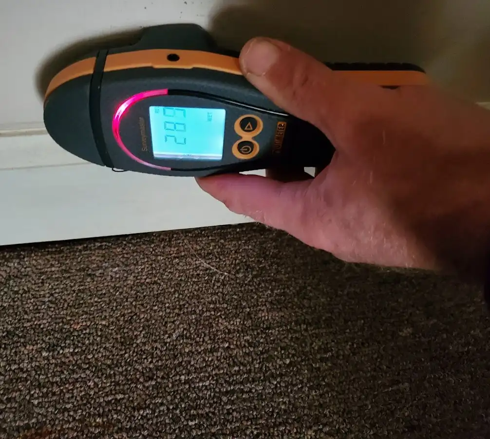 Moisture detection at baseboard during Storm Damage Restoration in Foley